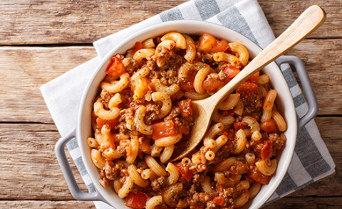 Beefy Macaroni and cheese in a bowl with a spoon