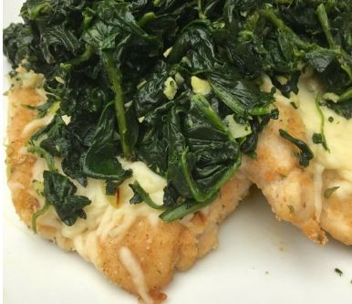 Mozzarella Chicken with Garlic Spinach on a plate